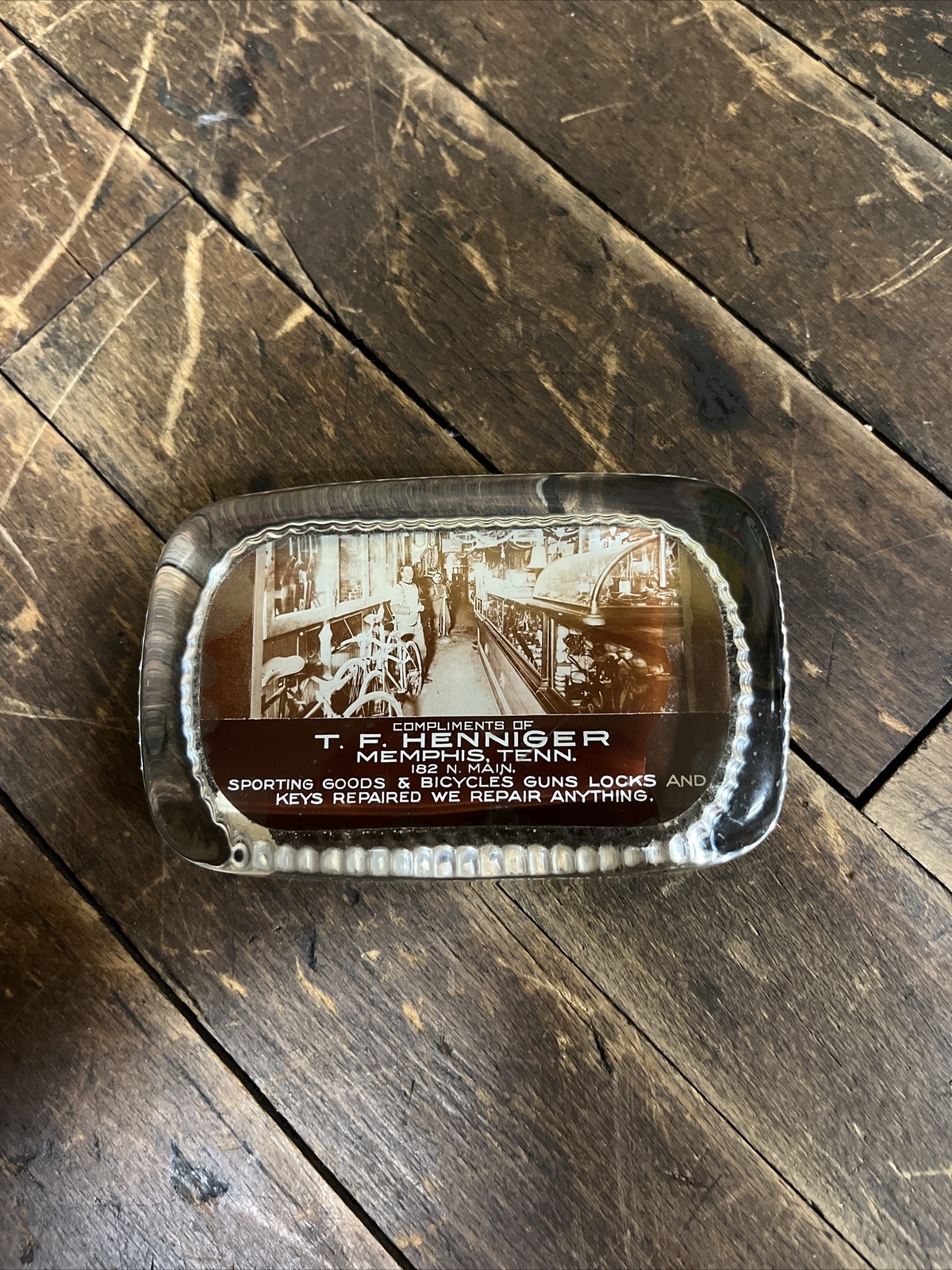 VINTAGE T. F. HENNIGER GLASS PAPERWEIGHT SIGN SPORTING GOODS BICYCLES GUNS STORE VINTAGE T. F. HENNIGER GLASS PAPERWEIGHT SIGN SPORTING GOODS BICYCLES GUNS STORE