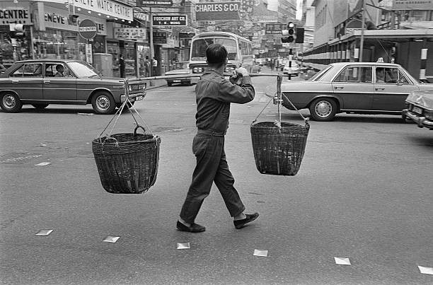 Hong Kong weight bearing crosses Hong Kong street carrying two bas- Old Photo