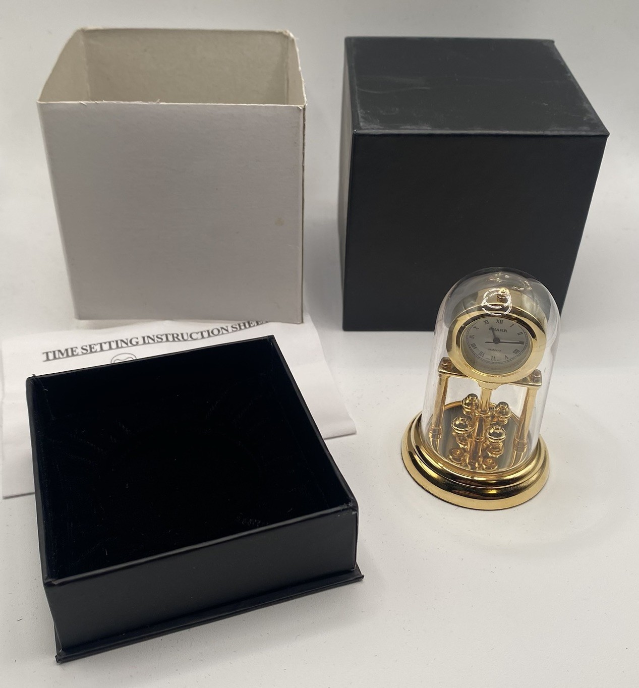 Vintage Sharp Miniature Brass Quartz Anniversary Clock Torsion Pendulum Novelty
