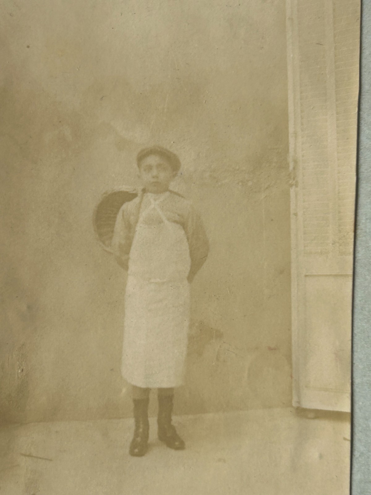 Antique Photograph of The Boy in White Arpon and Basket on The Back.
