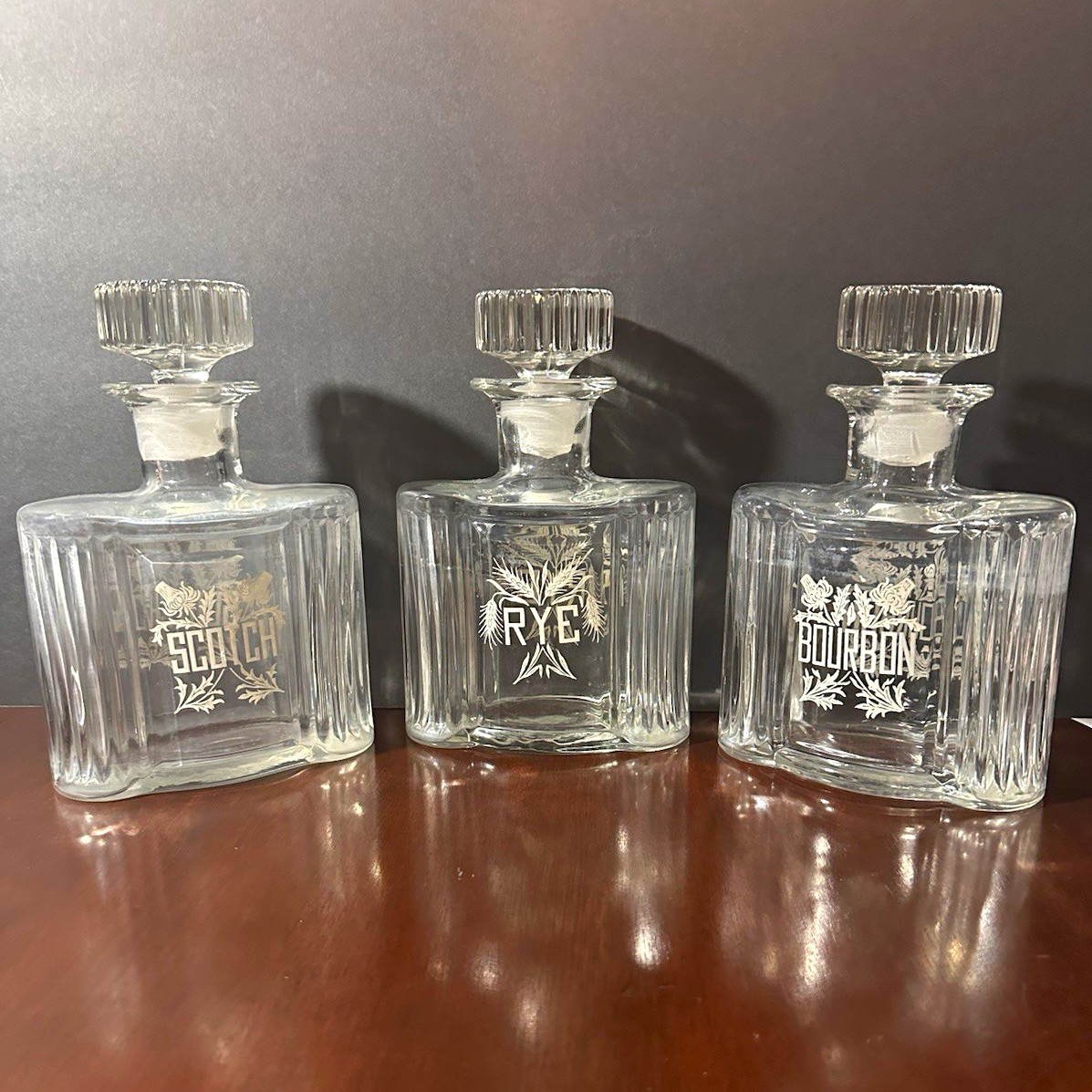 Vintage 1970s Set of 3 Clear Glass Square Floral Decanters w/ Stoppers Vintage 1970s Set of 3 Clear Glass Square Floral Decanters w/ Stoppers
