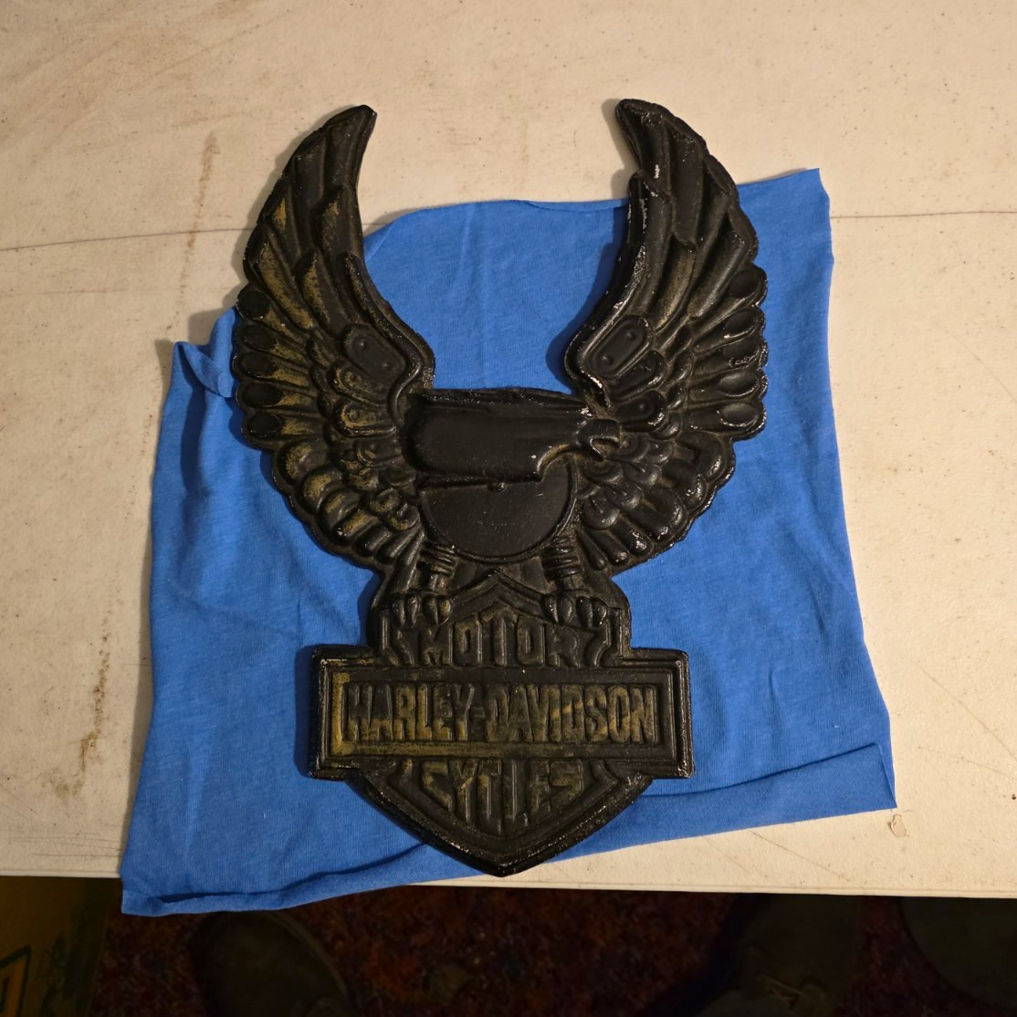 a vintage cast iron Harley-Davidson up-wing eagle bar and shield wall plaque