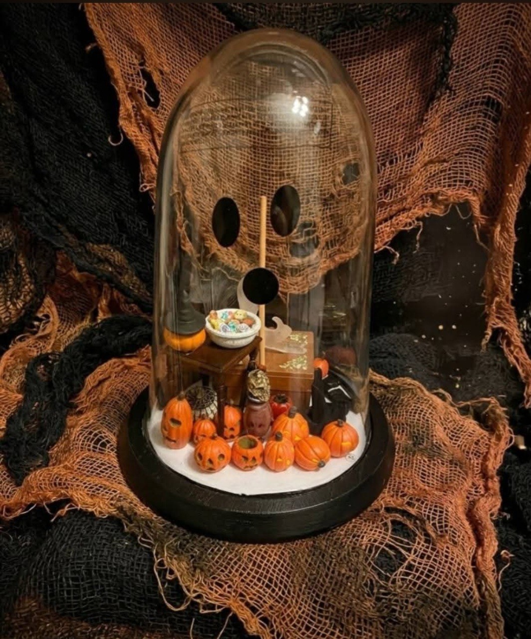A handmade miniature Halloween diorama inside a glass cloche dome