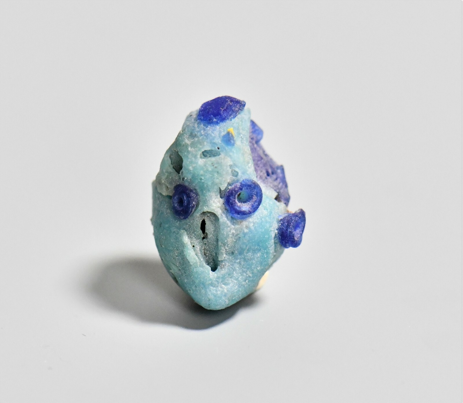 RARE ITEMS A Phoenician Glass Head Pendant