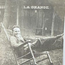 1910’s-20’s Photo Of Guy In Rocking Chair With “LA GRANGE” Sign On Building  picture