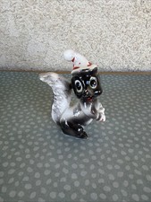 Ceramic Skunk Figurine Wearing White & Red Santa Hat, Approx 3 in Tall picture