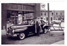 Man with 1941 Dodge in Front of Dodge Dealership Photo picture