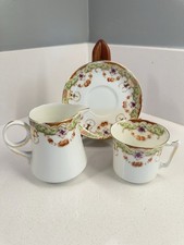 Vintage tea Cup, Saucer, Creamer With elegant floral and gold-trimmed picture