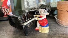 Vintage Betty Boop Seated At A Black Fran Piano Wearing Her Classic Red Dress picture