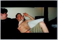 Vtg Color Snapshot Shirtless Man Couch Smoking Cigarette Candid 1990s picture