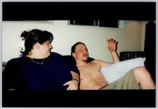 Vtg Color Snapshot Shirtless Man Waving Woman Hair Clip Couch 1990s picture