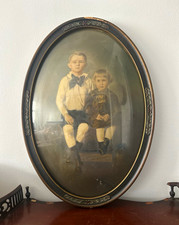 Antique oval picture frame with convex glass, containing a Victorian pastel port picture