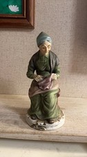 Vintage Porcelain Figurine of Elderly Woman Sewing picture