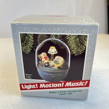 1989 Hallmark Keepsake Baby's First Christmas Ornament Motion Rock Cradle picture