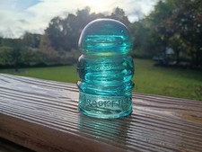 Beautiful aqua CD 112 Brookfield glass insulator. Interesting ghost embossing picture