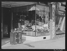 Photo:Columbus Georgia 1940 Pawn Shop Trunks Boots Main Street FSA picture