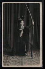 RPPC Postcard Girl in Indian Feather Headress and Moccassins Posing with Bow picture