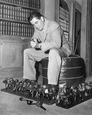 Canadian actor Glenn Ford sitting a study cleaning a pipe with rest- Old Photo picture