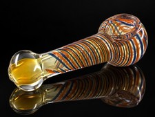A beautiful art glass tobacco hand pipe featuring warm golden amber and yellow picture