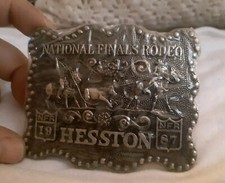 Vintage Hesston new National Finals Rodeo belt buckle. Gold tone. sealed picture