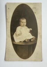 RPPC 1900-1910 - Baby In White Dress Sitting On Wood Table - Photo Postcard picture