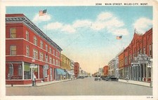 F48/ Miles City Montana Postcard c1920s Main Street Stores Autos picture