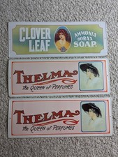 VTG 70s 2 Thelma the Queen of Perfumes & 1 Clover Leaf Embossed Tin Sign USA picture