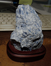 GORGEOUS TALL SPECIMEN OF BLUE KYANITE IN A WOOD STAND picture