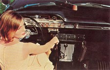 Young woman pictured from behind sits at the wheel of a car Old Photo picture
