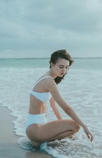 Candid_shot_of_a_woman_in_a_white_bikini_knee_1764844685342_95_11x17 picture