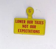 LOWER OUR TAXES NOT EXPECTATIONS FOLDING LIBERTARIAN 1960S VINTAGE  BUTTON PIN picture