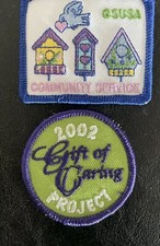2 NEW VINTAGE GIRL SCOUT PATCHES-COMMUNITY SERVICE,GIFT OF CARING PROJECT 2002 picture