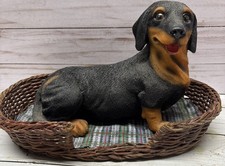 Resin Black & Tan Dachshund Dog In Wicker Bed 9”Long 6.50”Tall picture