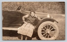 RPPC c1918 Young Woman Plaid Skirt Posing on Early Automobile Real Photo VELOX picture