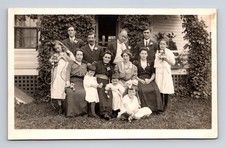 RPPC Family Portrait Men Women Girls Flowers Great Expressions Postcard picture