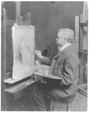 Painter Frank Willett, holding palette, seated in front of easel, - Old Photo picture