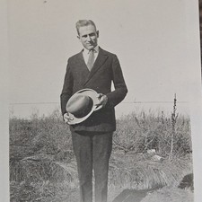 Vintage B&W Photo Snapshot of Young Man Holding Hat in Field | Blurry Feet picture