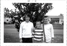 Three Smiling Siblings in Front Yard, 1962 Suburban B&W Snapshot Photo picture