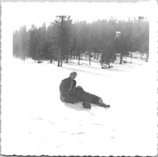 Two guys sitting in the snow laughing Found Photo V0896 picture