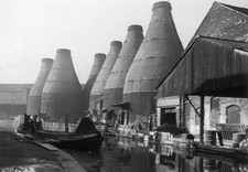 Barge a canal running alongside bottle kilns belonging to potteries- Old Photo picture