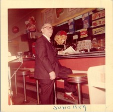 1959 Older Man Reading Newspaper at Diner Counter Photograph Coca-Cola picture