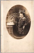 c1910s STUDIO Photo RPPC Postcard Little Girl with BIRTHDAY CAKE / Wicker Chair picture