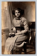 RPPC Young Lady Holding Flowers, Gift To Grandma ANTIQUE Postcard AZO 1904-1918 picture