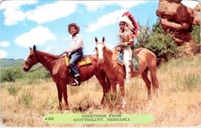 Scottsbluff, NE Nebraska GREETINGS Cowboy & Indian/Horses  ca1950's Postcard picture