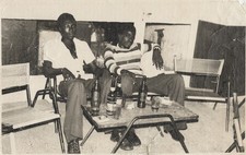 c. 1970's Two Young Men Lounging at Party Photograph by MALICK SIDIBE [Stamped] picture