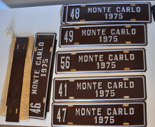 Lot 12 Vtg NEW 1975 Monte Carlo License Plate Toppers EMBOSSED STEEL 12x3 READ picture