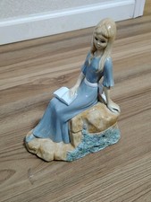Porcelain figurine posing sitting lady with book sculpture on Rock 5-19-1986  picture