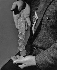 Close up of a man moving American coins one hand another 1960 Old Photo picture