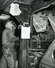 Worker uses a printing press produce posters an upcoming Atlanta 5- Old Photo picture