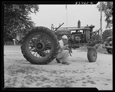 Photo:Newport, New Jersey (vicinity). Edward Hanby fixing a tractor picture
